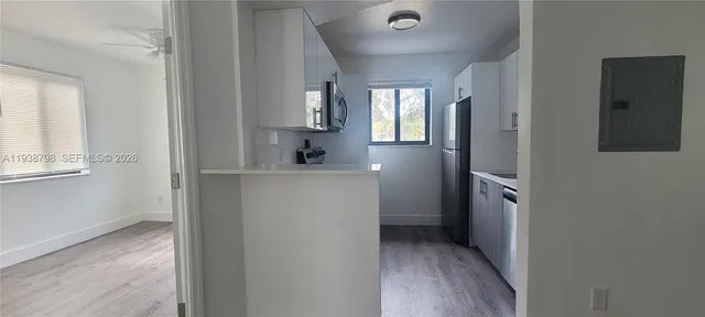 a view of hallway with sink and mirror