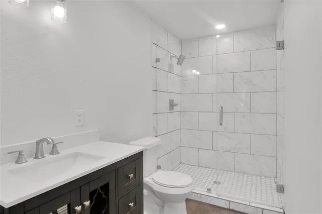 a bathroom with a sink toilet and shower