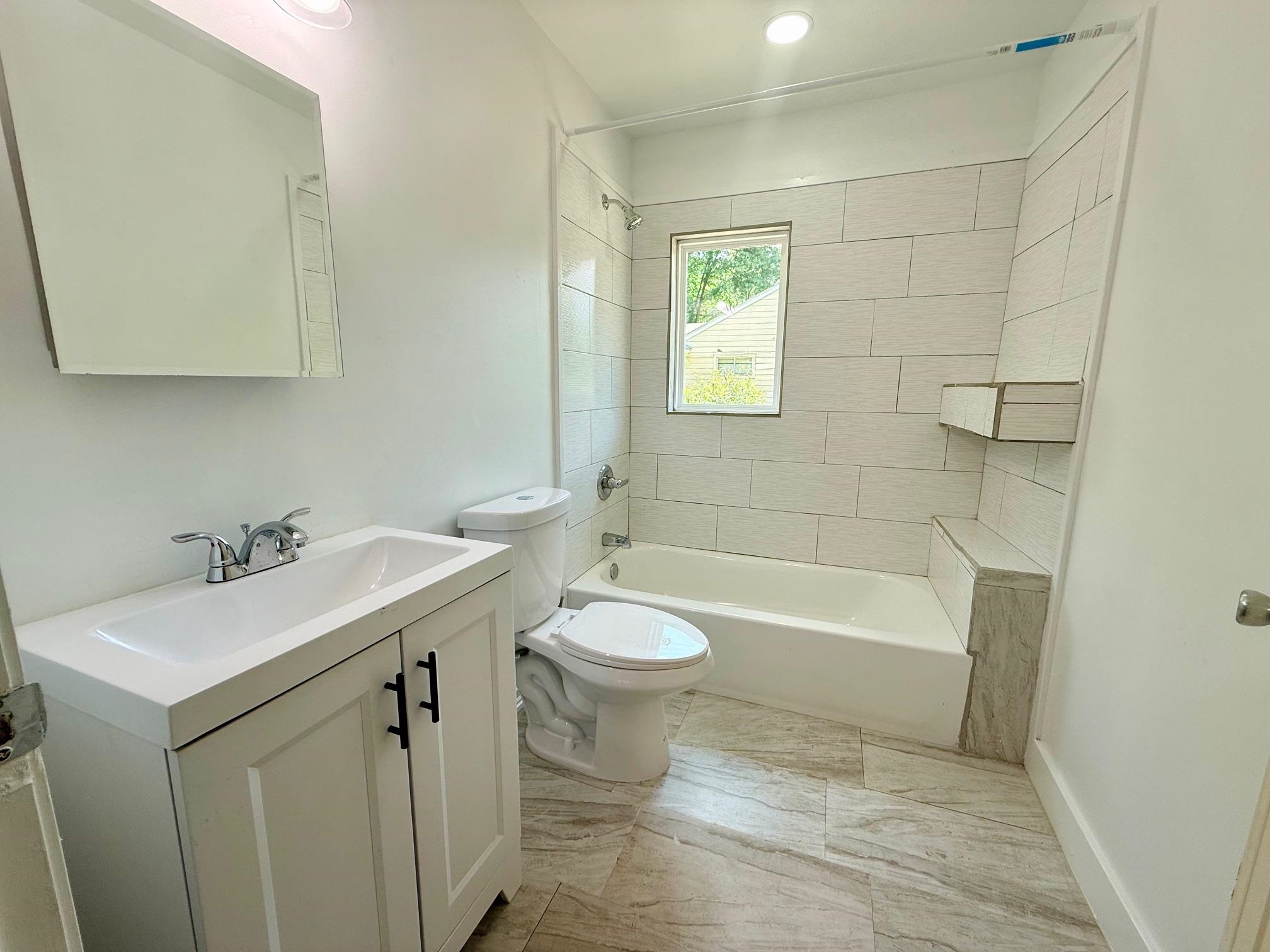 3054 Lotus Road Memphis, TN 38109 - Photo 22 of 29 a bathroom with a sink a toilet and bathtub
