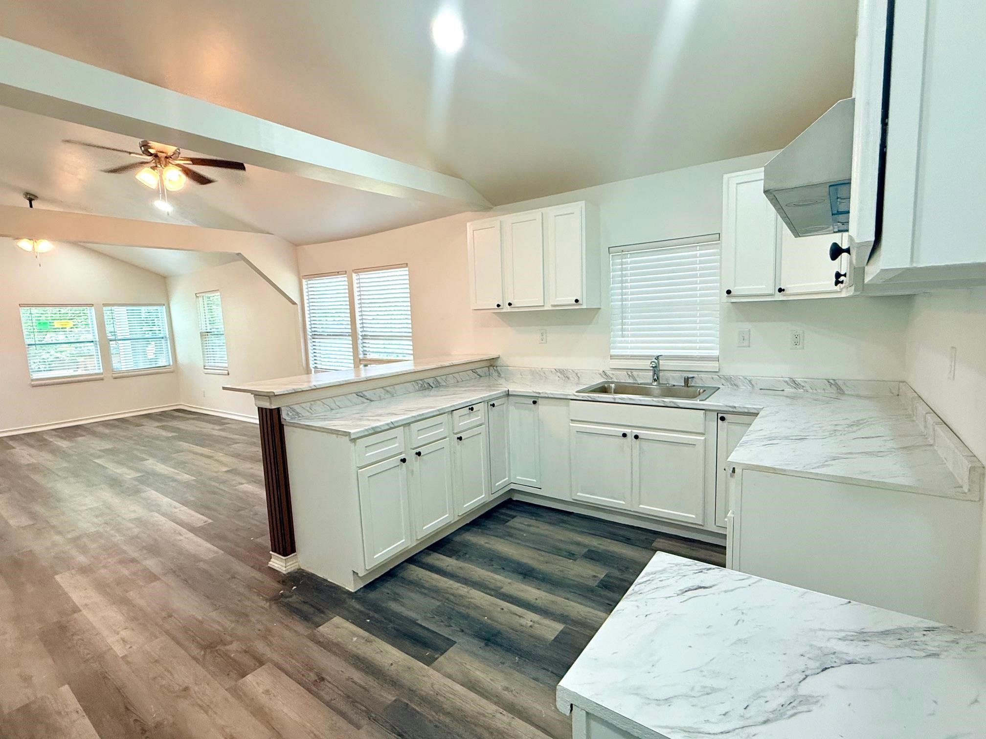 3054 Lotus Road Memphis, TN 38109 - Photo 7 of 29 a kitchen with a white cabinets stove and sink