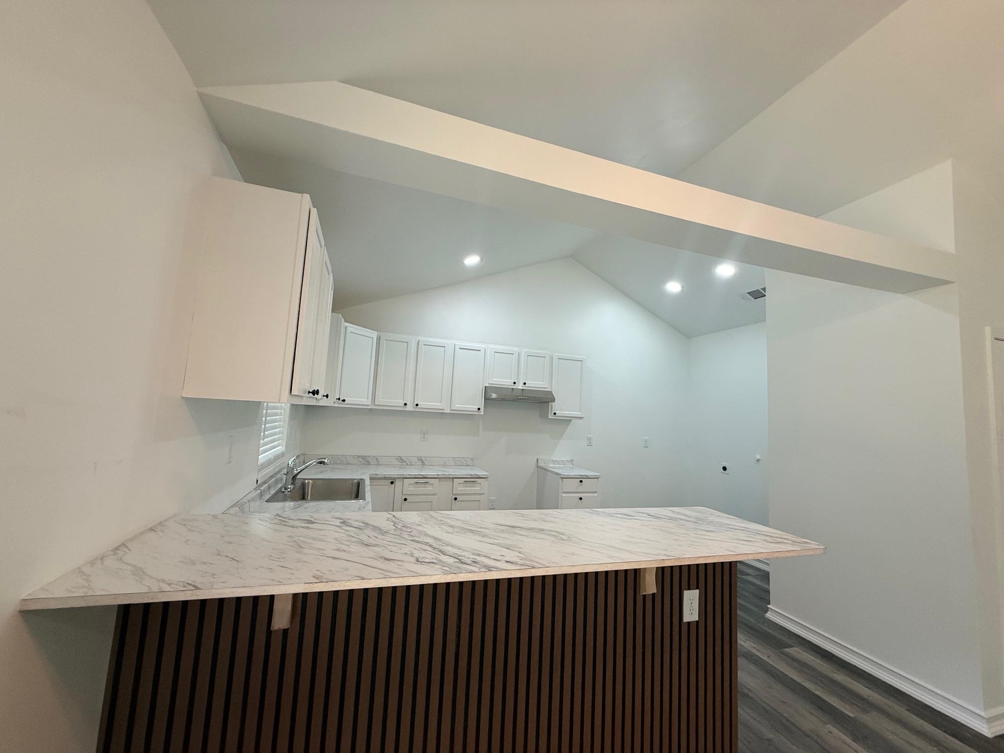 3054 Lotus Road Memphis, TN 38109 - Photo 10 of 29 a kitchen with a sink a counter top space and cabinets
