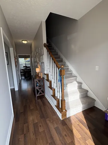 a view of entryway and hall with wooden floor