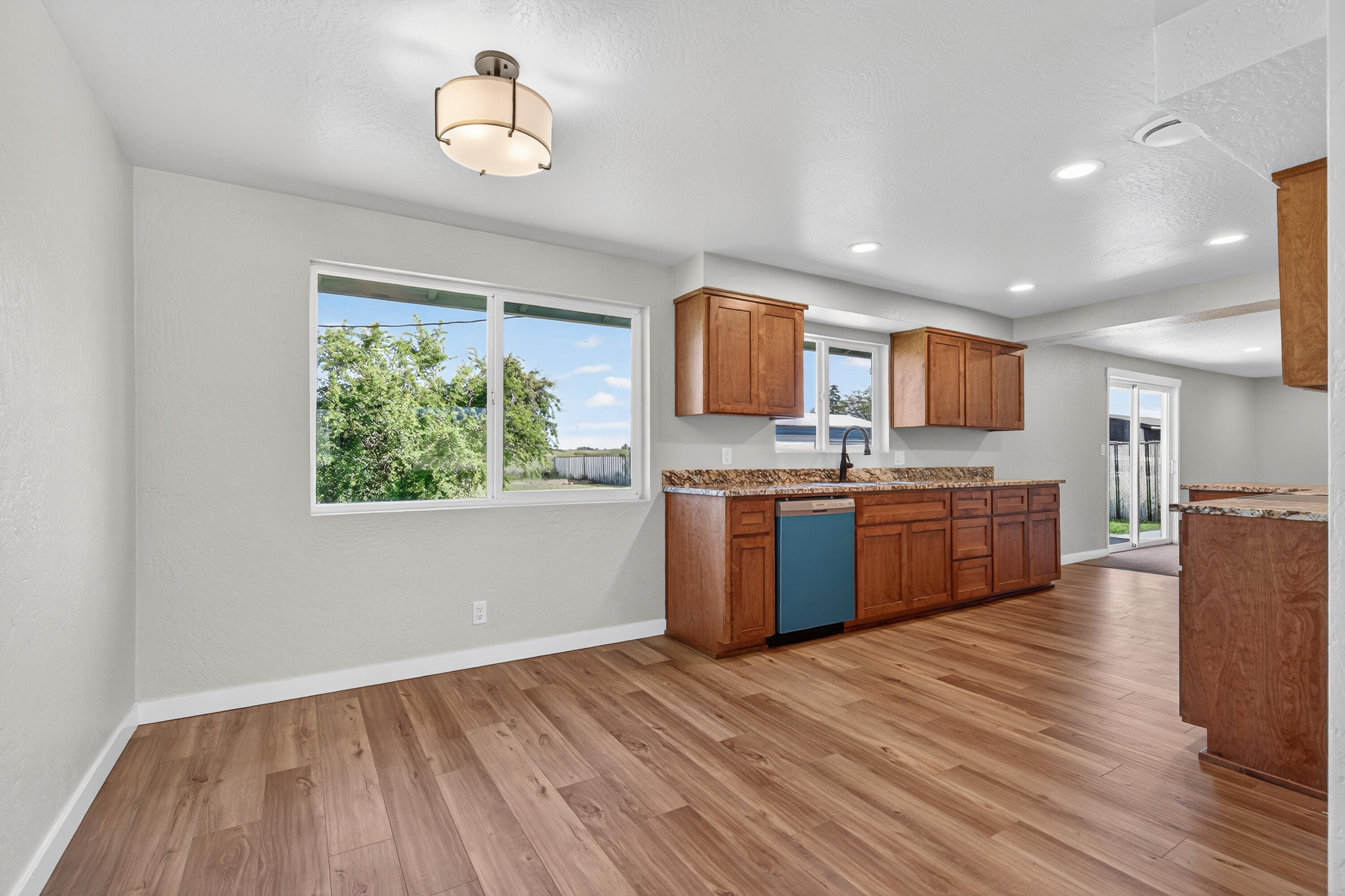 550 Experiment Station Road Medford, OR 97501 - Photo 11 of 27 a kitchen with stainless steel appliances kitchen island wooden cabinets and granite counter tops