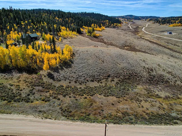 a view of a yard with wooden fence