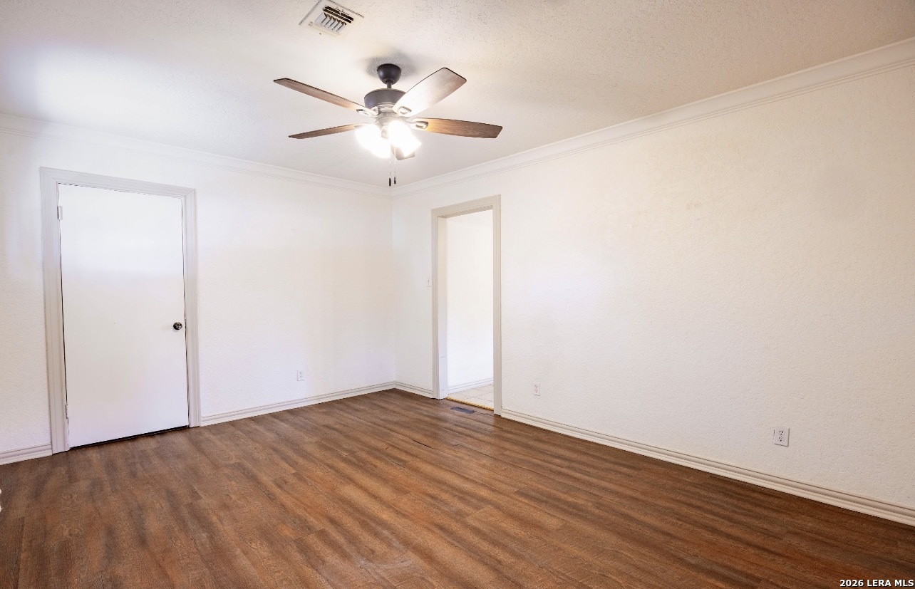 149 South Carroll Street Poth, TX 78147 - Photo 5 of 28 an empty room with wooden floor fan and windows