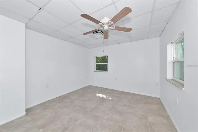 an empty room with closet and windows