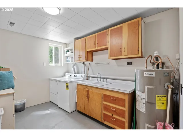 a kitchen with a sink cabinets and window