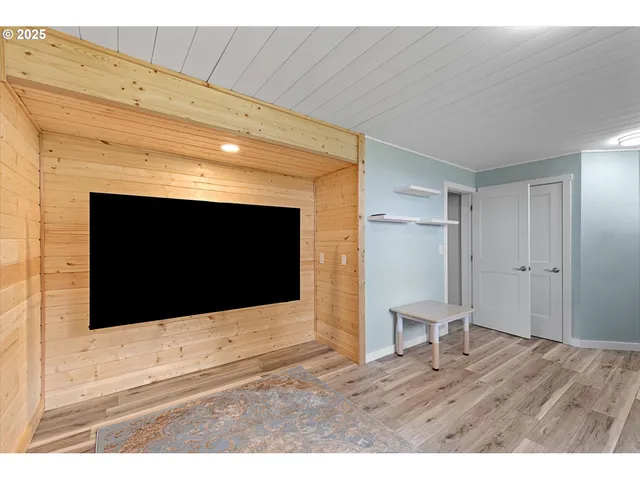a living room with a fireplace and a flat screen tv