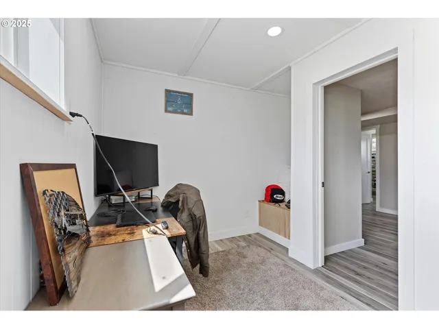 a view of a workspace with furniture and wooden floor