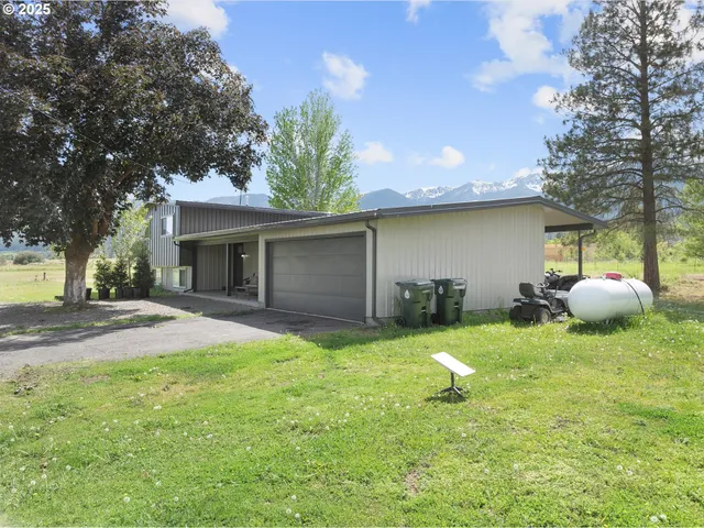 a view of a backyard with table and chairs and a fire pit