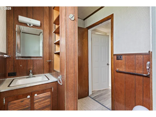 a bathroom with a sink a mirror and a shower