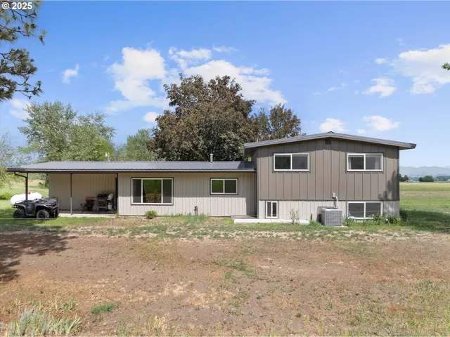a house that has a tree in front of it