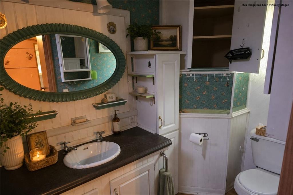 2495 Leach Road Linesville, PA 16424 - Photo 12 of 27 a bathroom with a toilet a sink and mirror