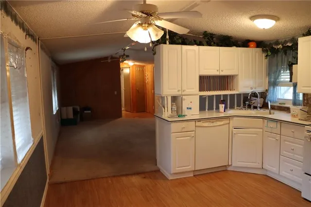 a kitchen with stainless steel appliances granite countertop a sink a stove and a refrigerator