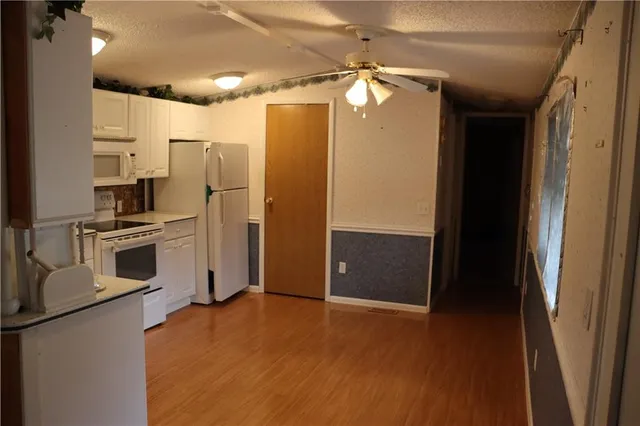 a kitchen with stainless steel appliances a refrigerator and a stove top oven