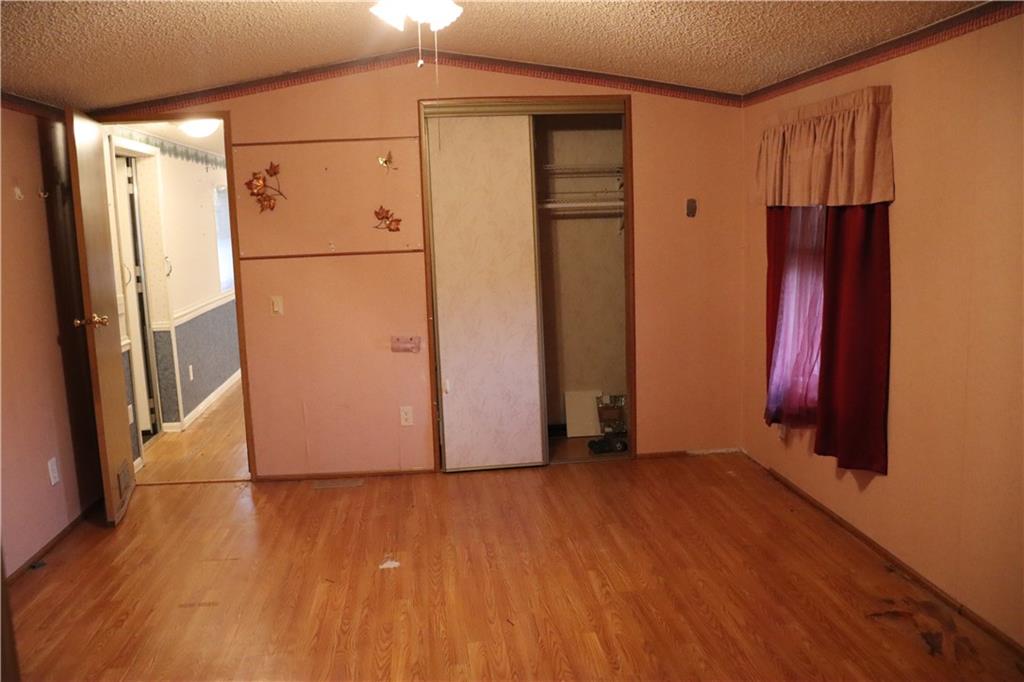 2495 Leach Road Linesville, PA 16424 - Photo 15 of 27 a view of a room with wooden floor and a refrigerator