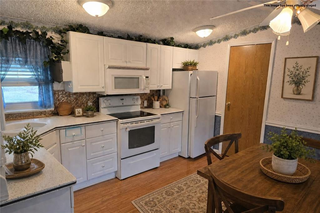 2495 Leach Road Linesville, PA 16424 - Photo 21 of 27 a kitchen with a sink appliances and cabinets