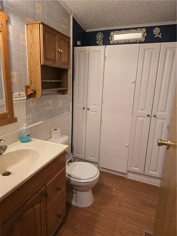 a bathroom with a sink a toilet and a mirror