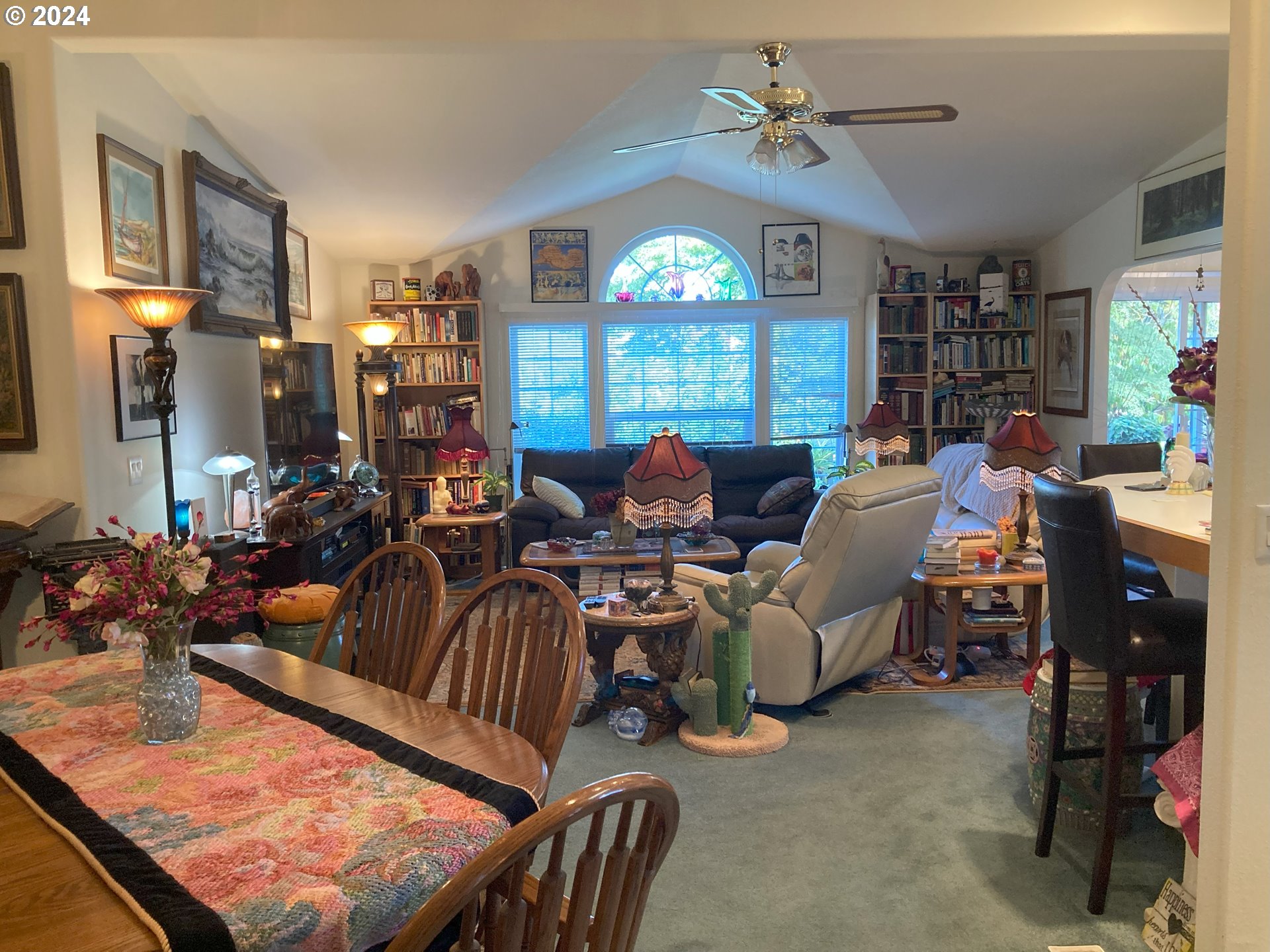 4055 Royal Avenue, Unit 25 Eugene, OR 97402 - Photo 11 of 42 a living room with furniture a chandelier and a large window