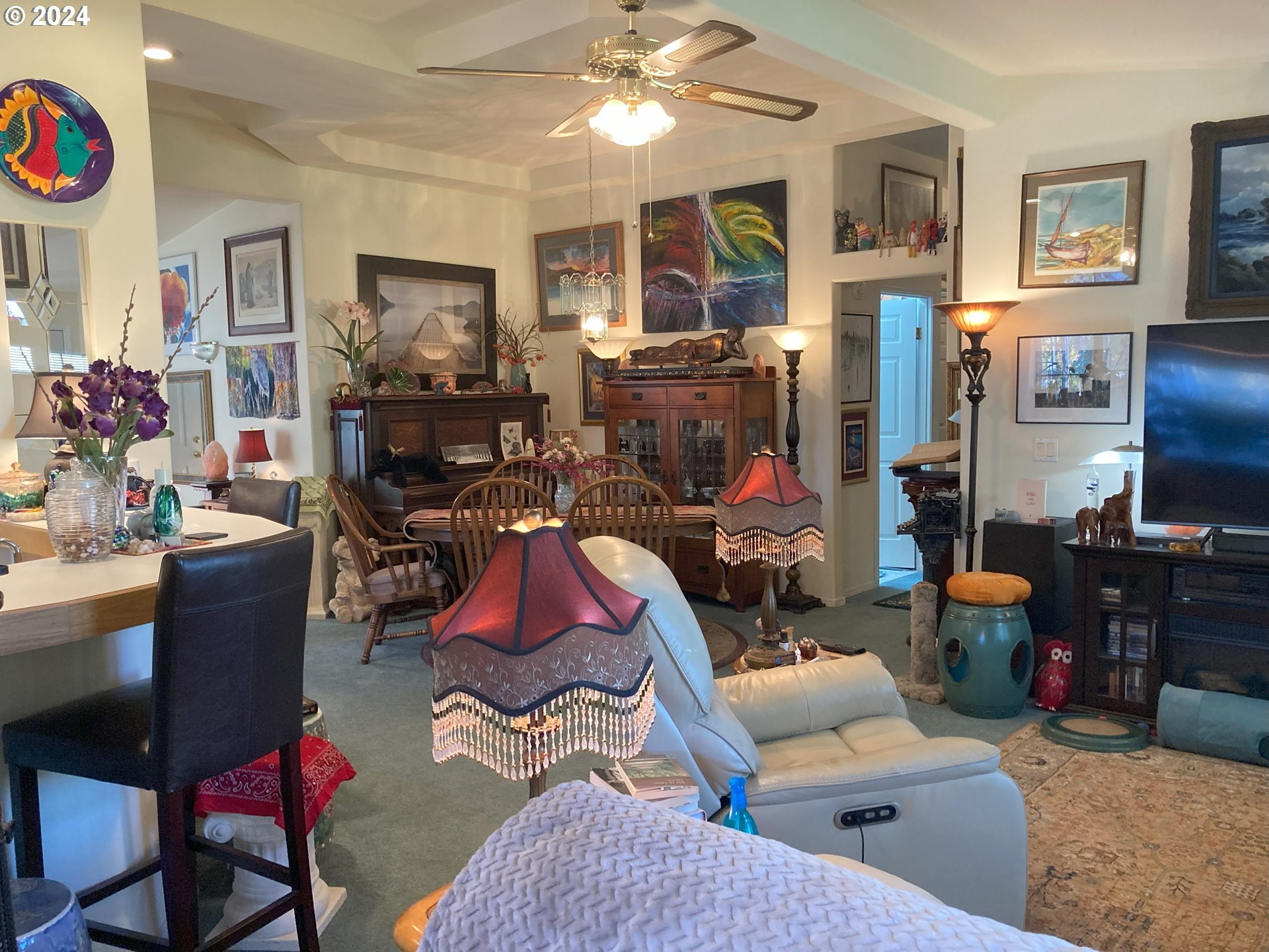 4055 Royal Avenue, Unit 25 Eugene, OR 97402 - Photo 20 of 42 a living room with furniture a flat screen tv and a dining table