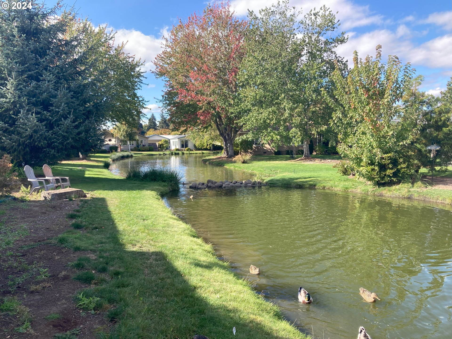 4055 Royal Avenue, Unit 25 Eugene, OR 97402 - Photo 35 of 42 a view of a lake with a yard and swimming pool