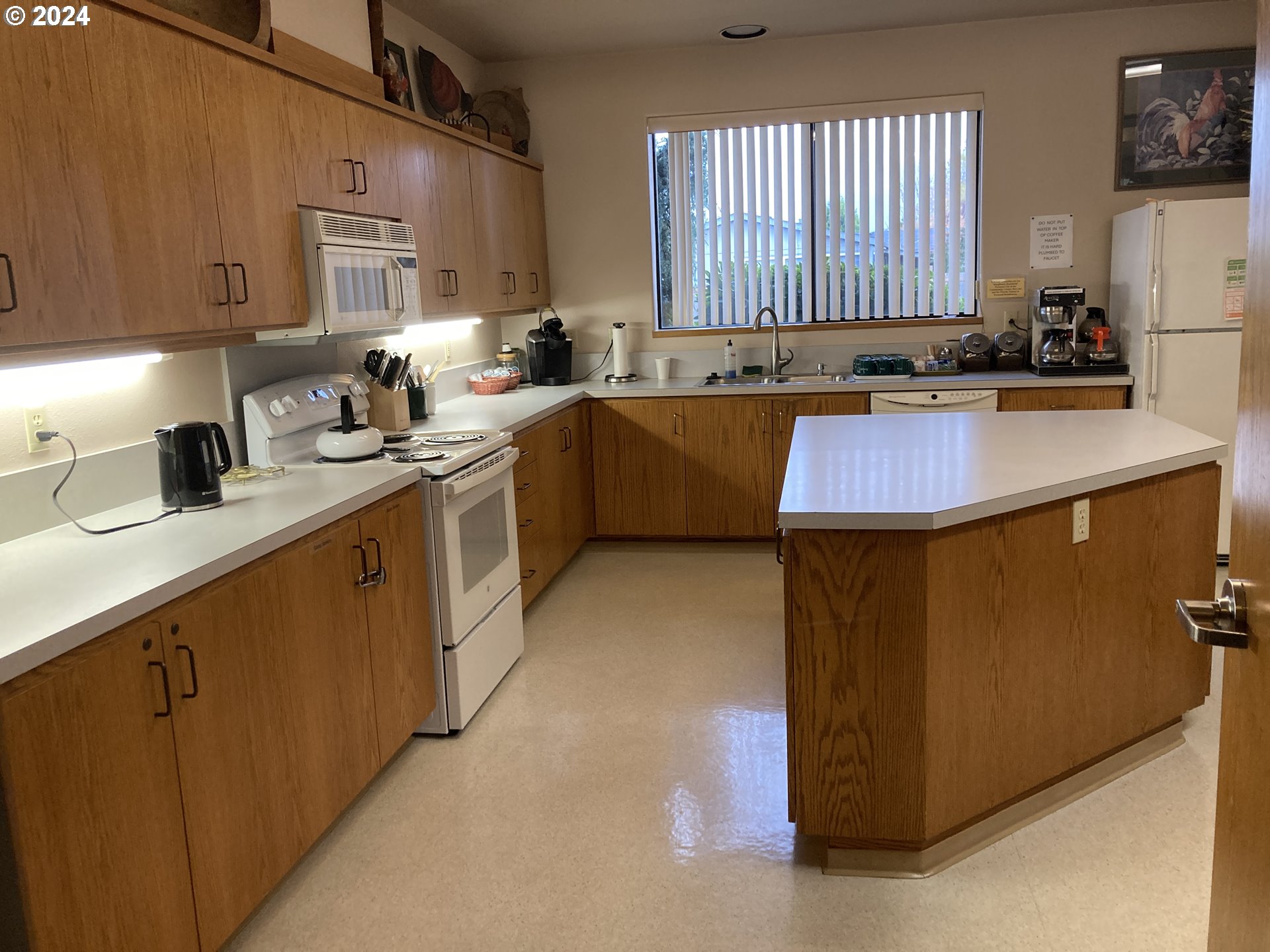 4055 Royal Avenue, Unit 25 Eugene, OR 97402 - Photo 40 of 42 a kitchen with kitchen island granite countertop a sink counter top space and cabinets