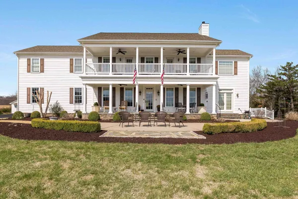a living room with furniture fireplace and a large window
