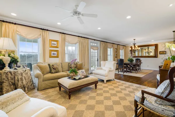 a living room with furniture bathtub and wooden floor