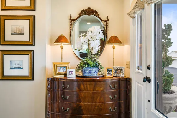 a large white room with a large mirror and a sink