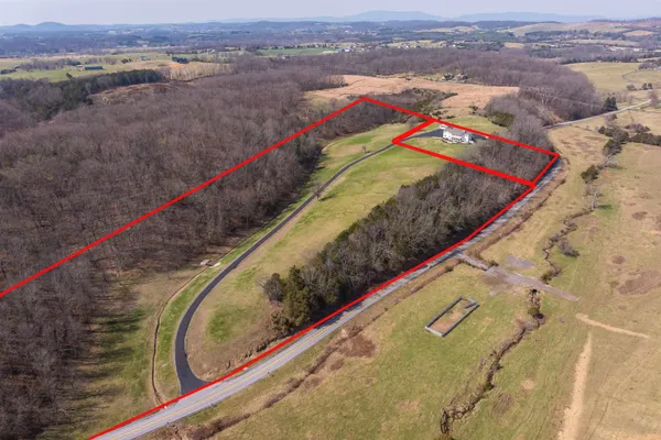 a view of a field with mountains in the background