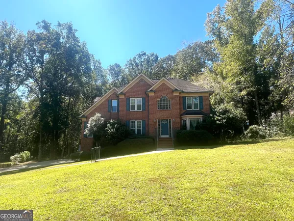 a front view of a house with a yard