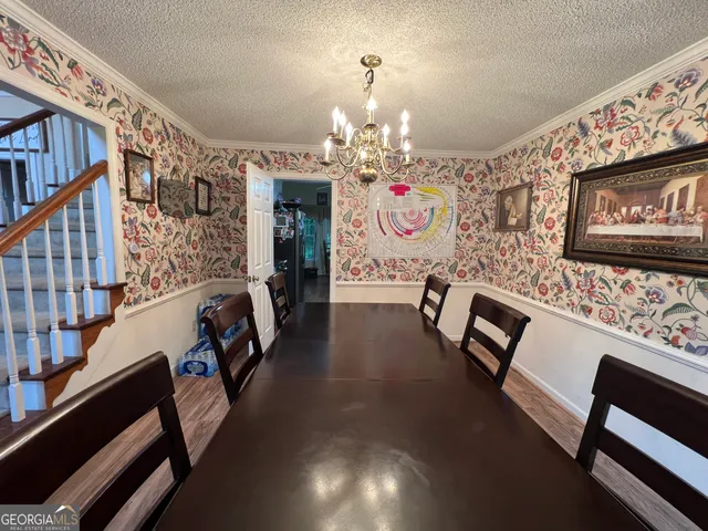 a kitchen with wooden floors and white appliances