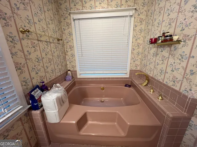 a bathroom with a sink a mirror and a shower