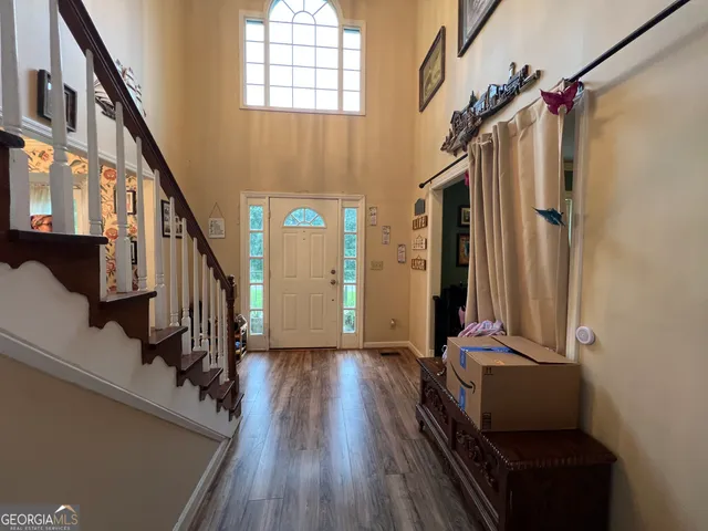 a view of an entryway with wooden floor and door