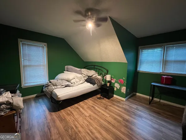 a bed room with two bed and a television