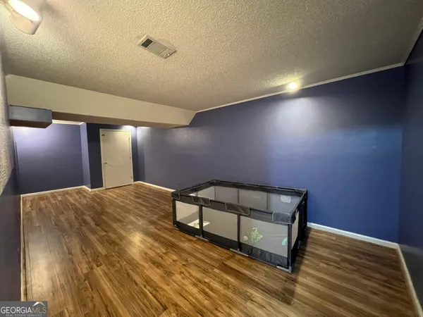 a view of a room with wooden floor