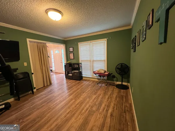 a view of a dining room with furniture and wooden floor