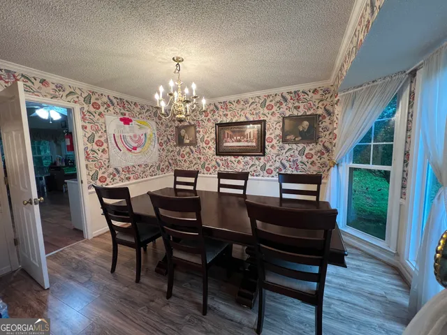 a view of a livingroom with furniture and hardwood floor