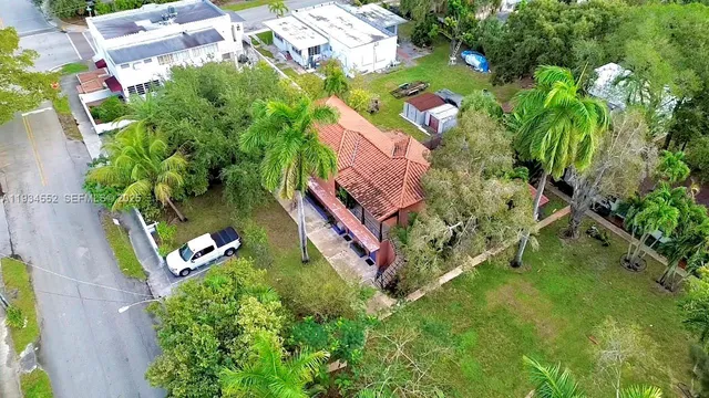 an aerial view of a house with a yard and lake view