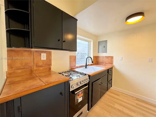 a kitchen that has a sink and a stove