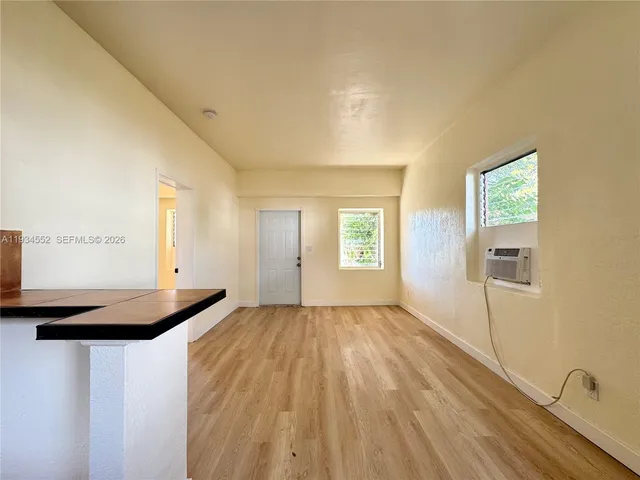 a view of a livingroom and a kitchen
