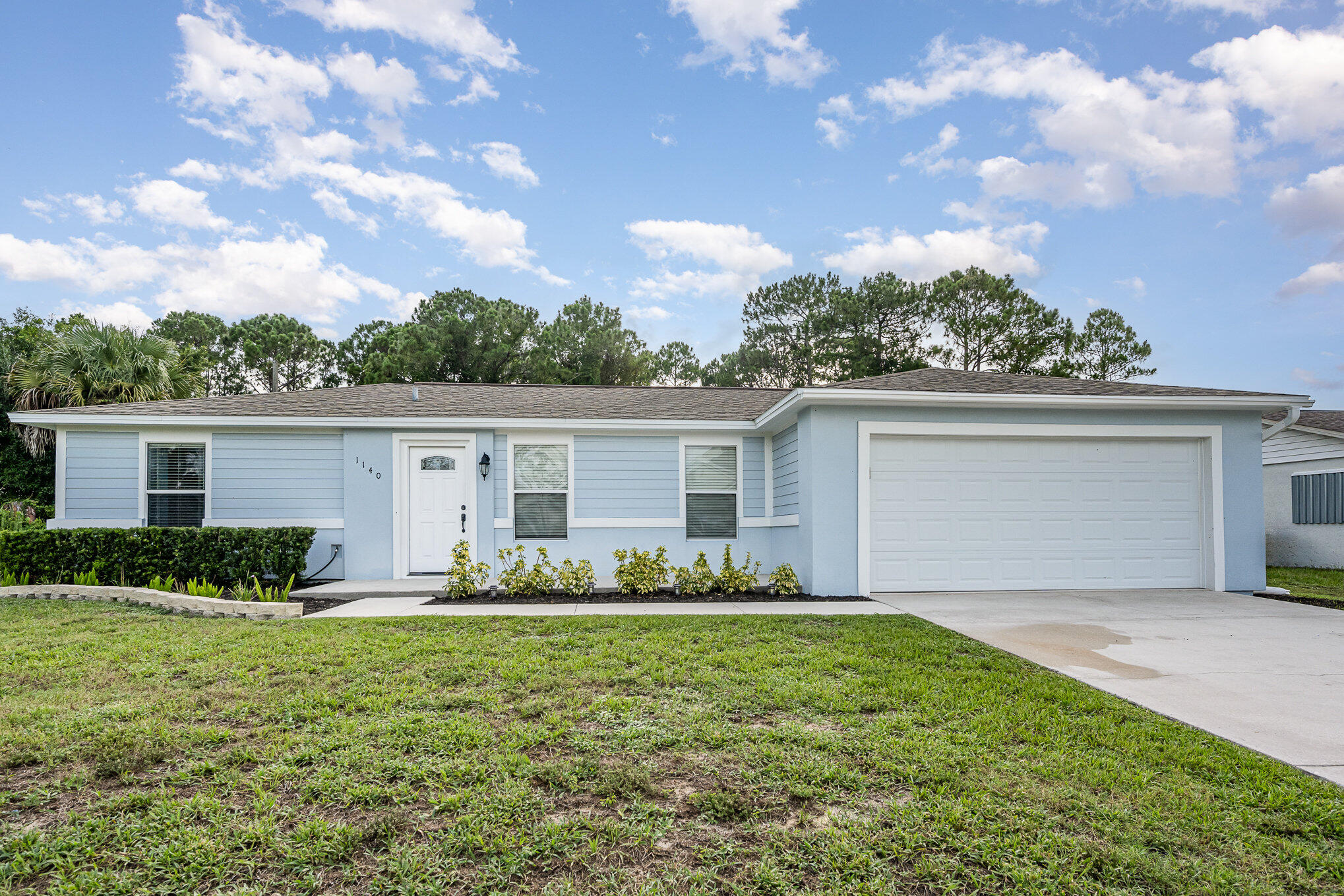 1140 Commerce Road Southeast Palm Bay, FL 32909 - Photo 1 of 24 a front view of house with yard and green space