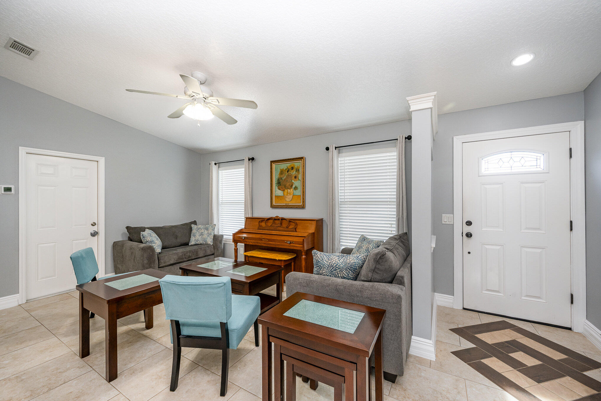 1140 Commerce Road Southeast Palm Bay, FL 32909 - Photo 11 of 24 a living room with furniture a ceiling fan and a rug