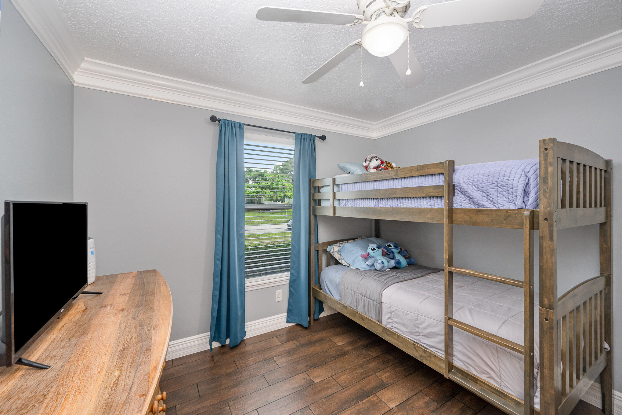 1140 Commerce Road Southeast Palm Bay, FL 32909 - Photo 18 of 24 a bedroom with a bed and a chandelier