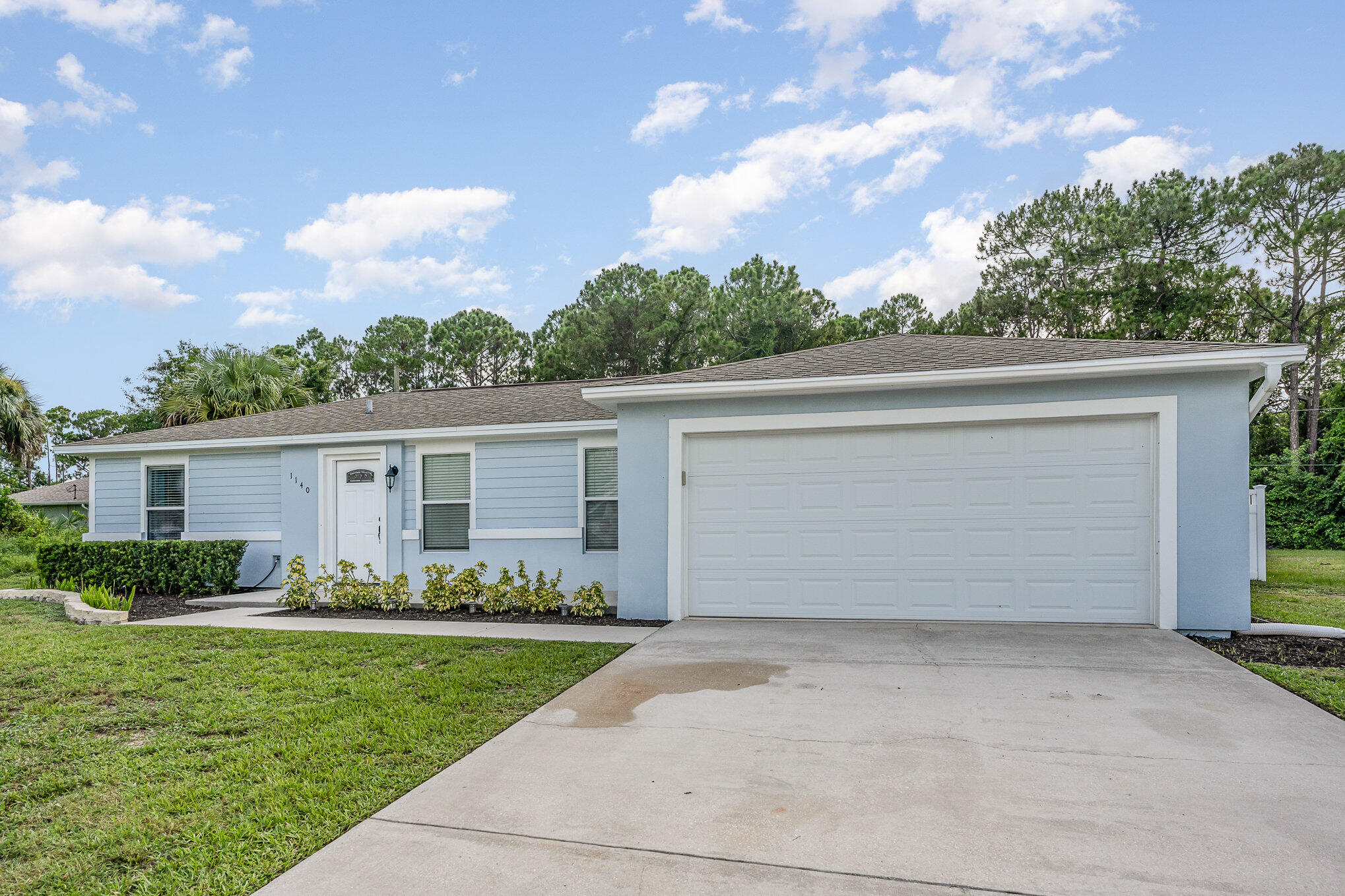 1140 Commerce Road Southeast Palm Bay, FL 32909 - Photo 2 of 24 front view of house with a yard