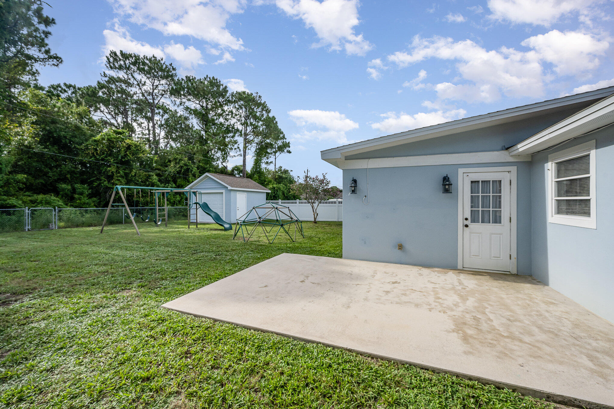 1140 Commerce Road Southeast Palm Bay, FL 32909 - Photo 21 of 24 a front view of a house with yard and green space
