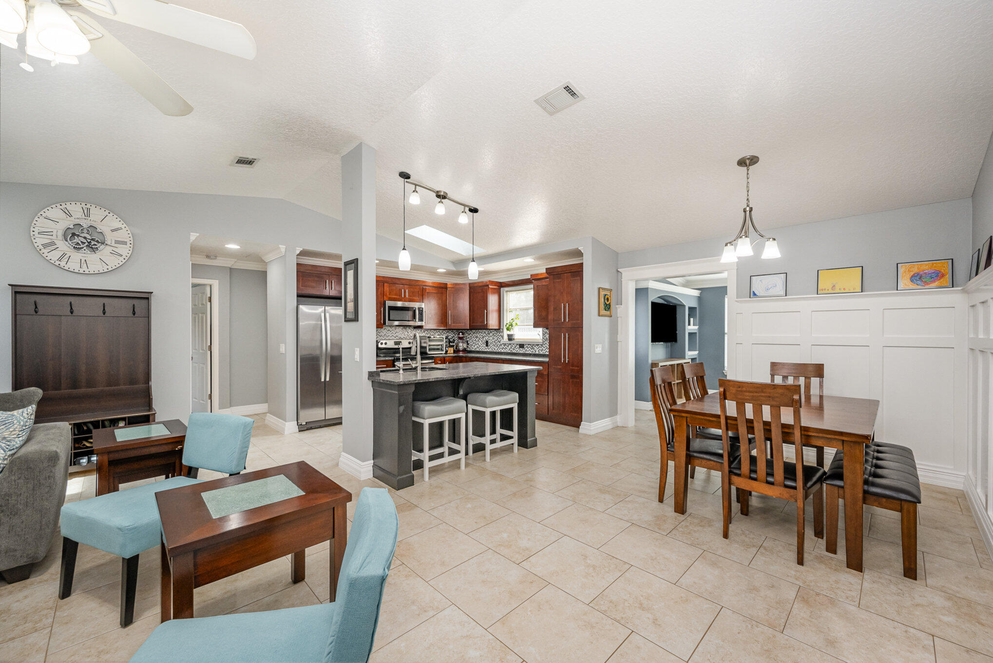 1140 Commerce Road Southeast Palm Bay, FL 32909 - Photo 5 of 24 a living room with furniture a dining table and a chandelier