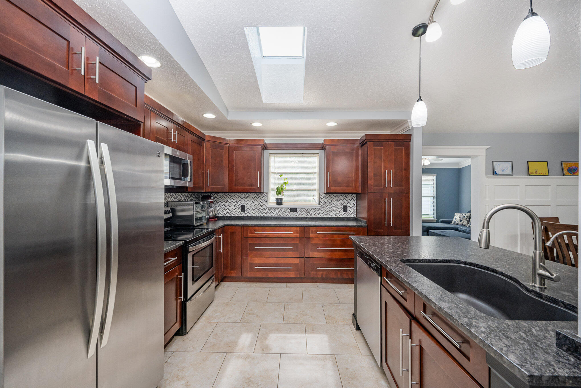 1140 Commerce Road Southeast Palm Bay, FL 32909 - Photo 8 of 24 a kitchen with granite countertop a refrigerator and a sink