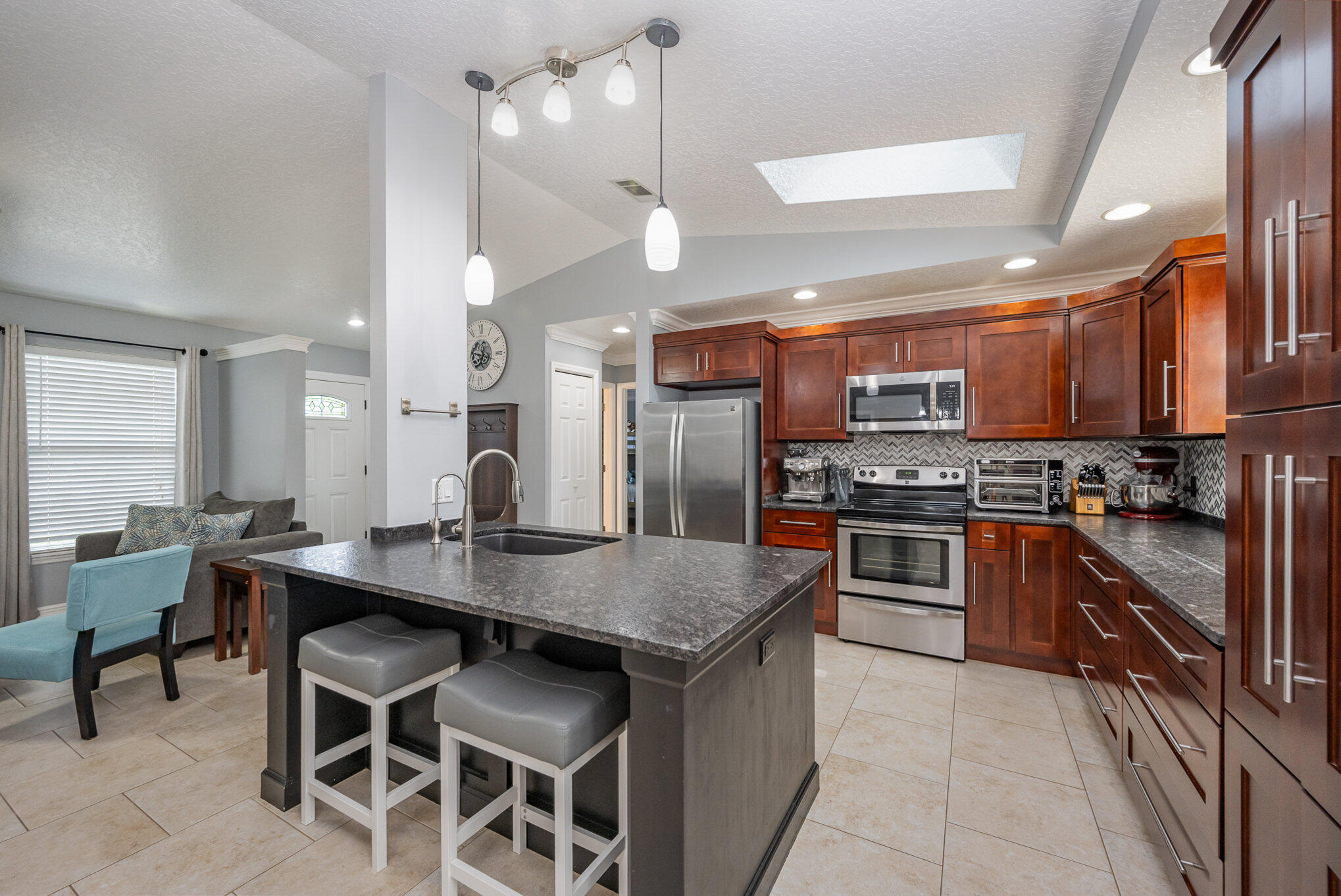 1140 Commerce Road Southeast Palm Bay, FL 32909 - Photo 10 of 24 a kitchen with stainless steel appliances granite countertop a stove a sink a oven a dining table and chairs