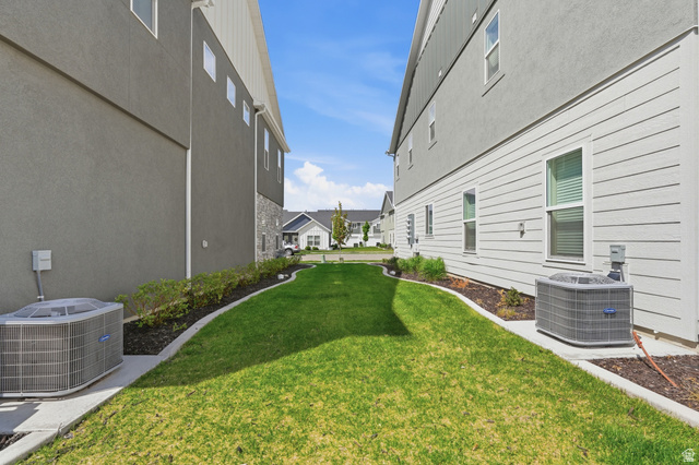 1173 West 1870 South Logan, UT 84321 - Photo 27 of 33 Landscaped side yard with manicured lawn, concrete curbing, and decorative rock beds